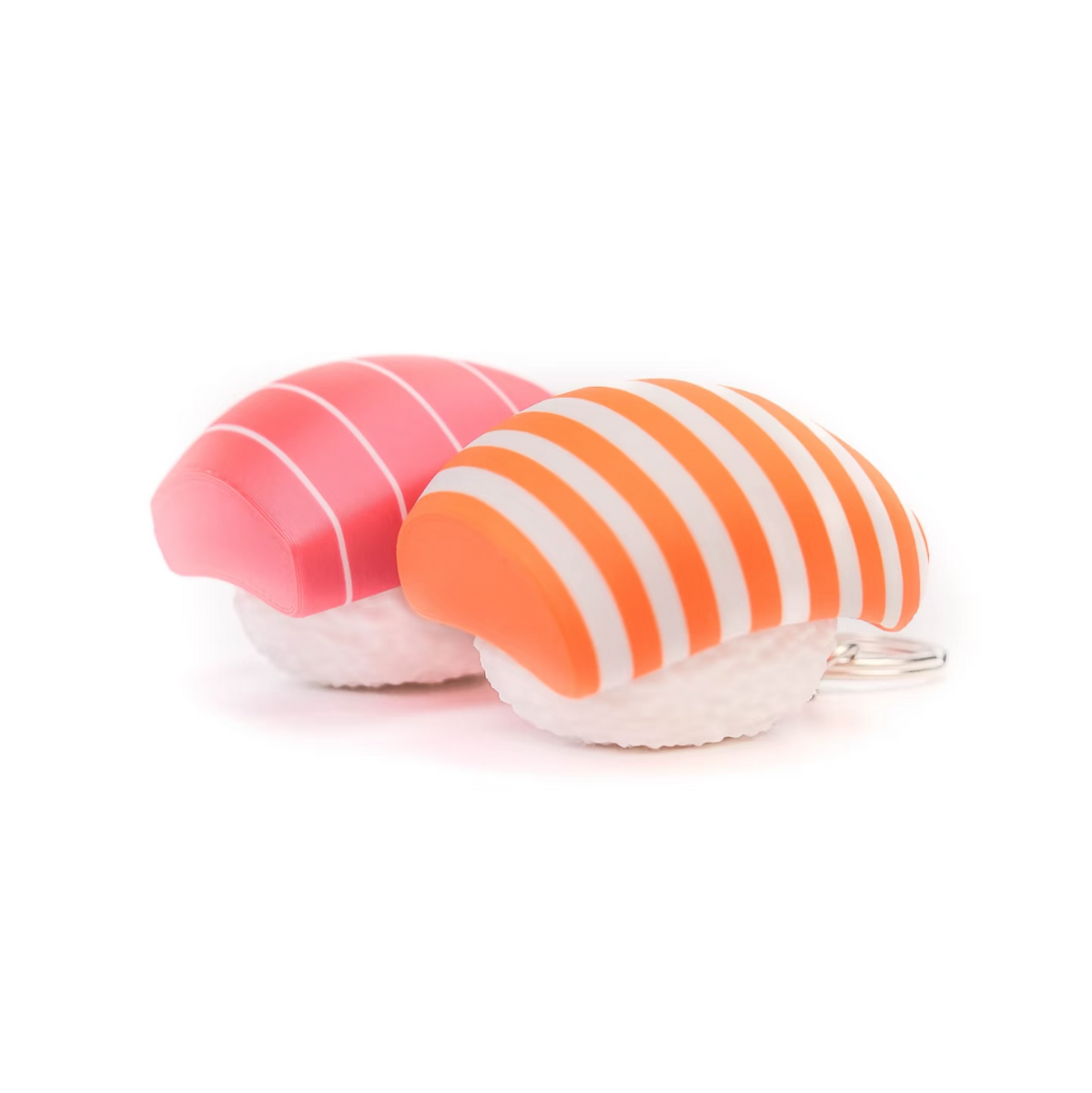 Two sushi-themed keychains shaped like nigiri, one pink with white stripes and one orange and white striped, displayed on a plain white background.