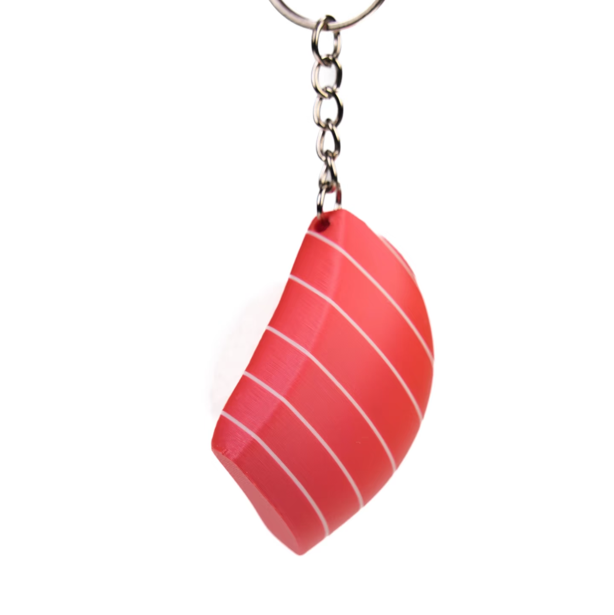 A novelty keychain shaped like a slice of red salmon sushi with white stripes, attached to a silver metal split ring, shown on a plain white background.