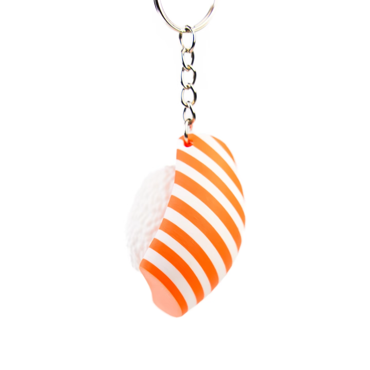 An orange and white striped silicone keychain charm shaped like a seashell, attached to a silver metal key ring, shown against a plain white background.