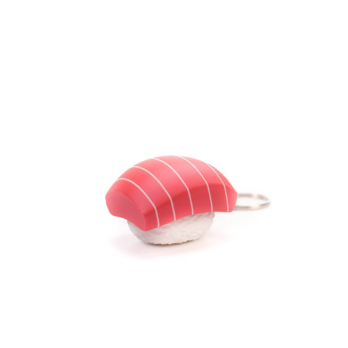 A small sushi-shaped accessory, likely a charm or keychain, featuring a pink and white striped top resembling tuna or salmon nigiri with a white base, shown on a plain white background.