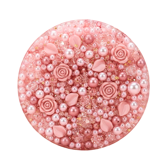 Top down close up of the picky pad filled with pink pearls, rose charms, and shimmering beads.